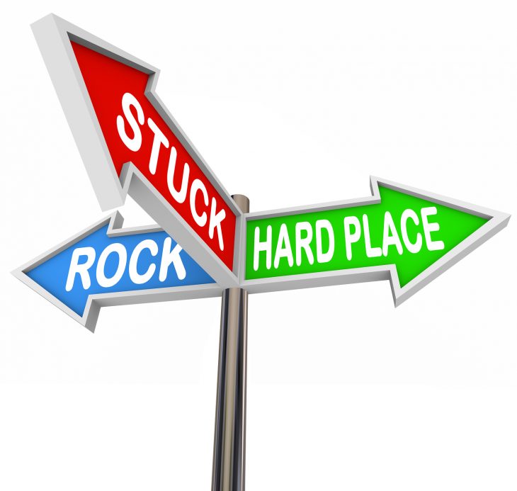 bigstock-Stuck-Between-Rock-and-Hard-Pl-54626387.jpg
