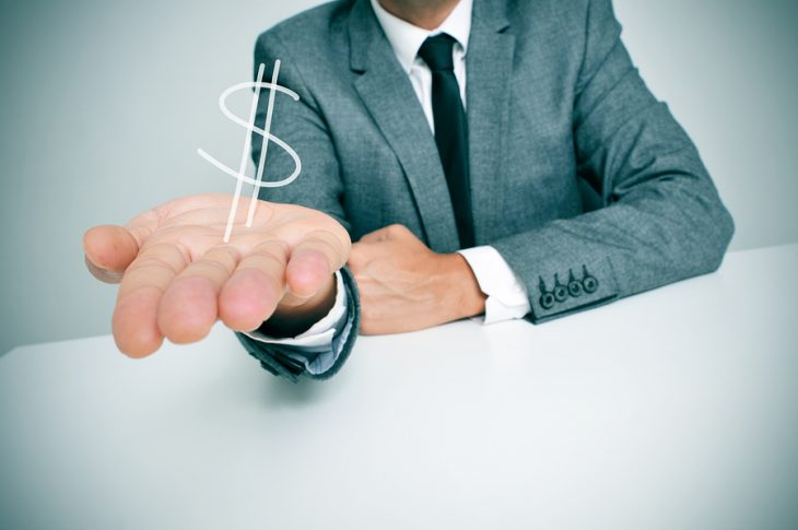 bigstock-a-businessman-sitting-in-a-des-58975436.jpg
