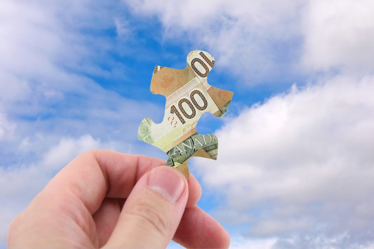 bigstock-Hand-Hold-Canadian-Dollar-Puzz-376375.jpg
