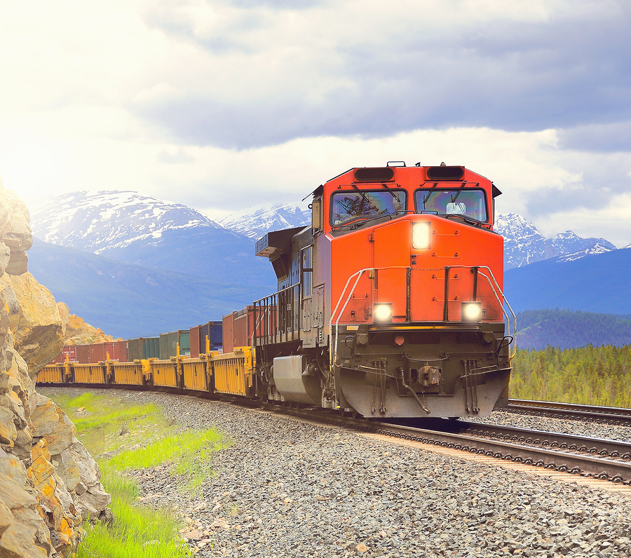 bigstock-Long-Freight-Train-Moves-Throu-235672795.jpg